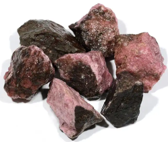 Raw Rhodonite stones combining pink and black tones for deep emotional healing