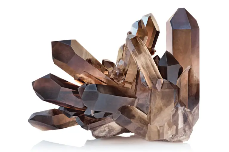 Extreme close-up of a glassy Smoky Quartz crystal cluster, featuring sharply defined trigonal prisms in dark brown to black hues. A natural, translucent mineral specimen showcasing the trigonal crystal system.