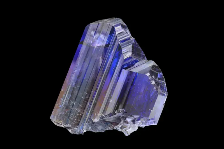 Natural Tanzanite crystal from Arusha, Tanzania, showing elongated prismatic form typical of the orthorhombic crystal system. A vivid blue-violet variety of Zoisite.